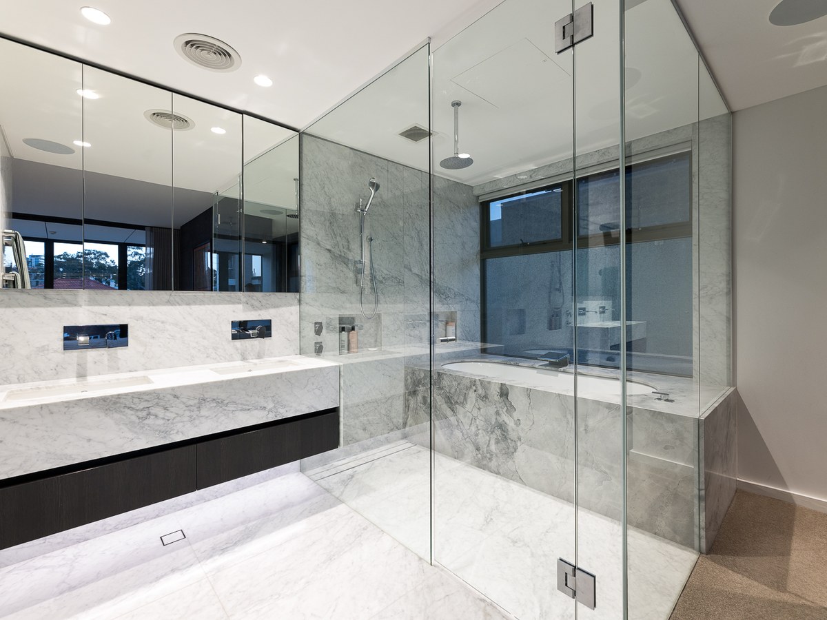 Master ensuite in full marble with twin vanity, walk-in rain shower and deep bath