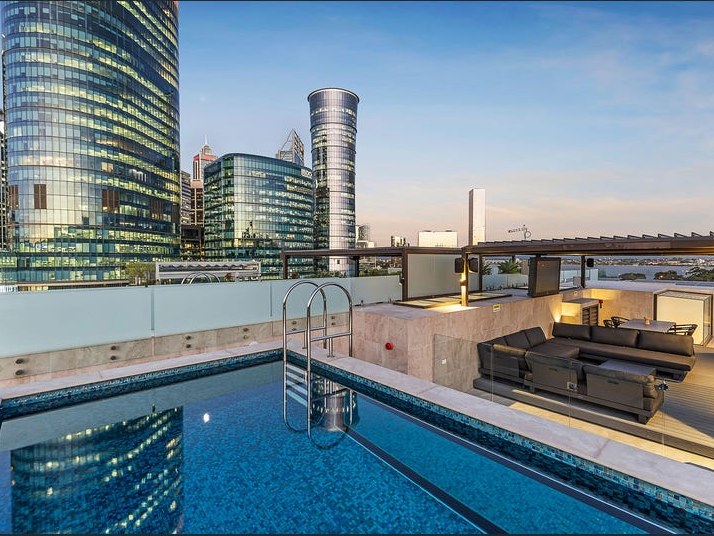 The private rooftop pool at the Mount St Penthouse with the Perth city skyline beyond